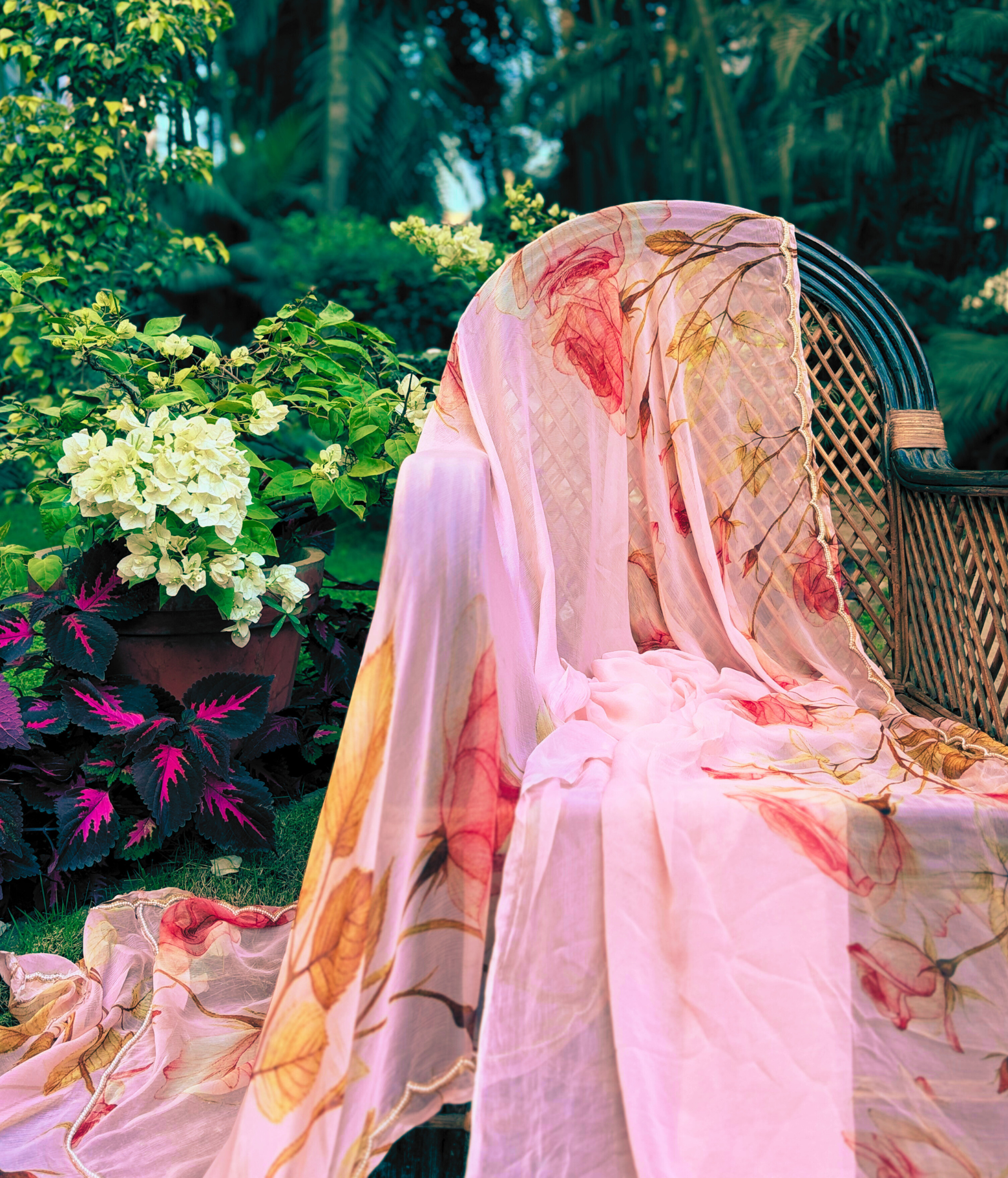 Floral printed Chiffon Saree layed over a chair in the garden